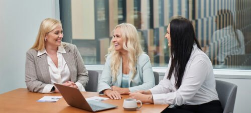 3 women., working at Baltic Assist. discussing benefits of outsourcing finance.