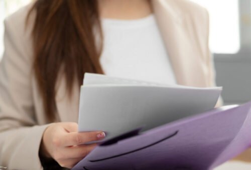 Woman reviewing Baltic Assist HR documentation kit