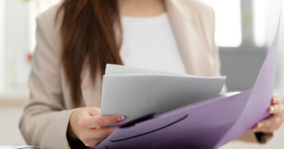 Woman reviewing Baltic Assist HR documentation kit
