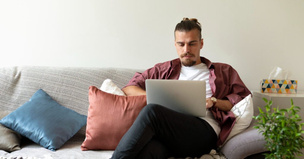 Remote worker on couch in home with pillows