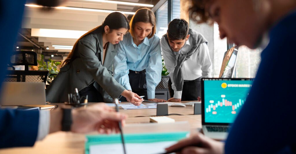 people analyzing checking finance graphs office scaled e1758622432125