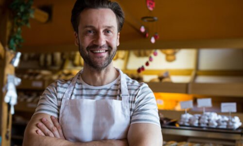 portrait smiling owner standing bakery shop scaled e1756716883786