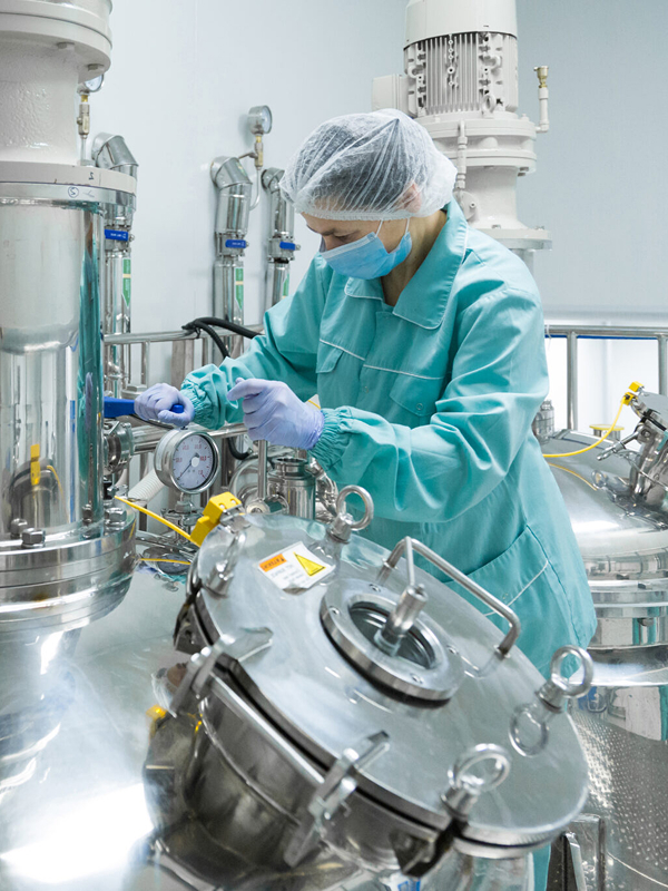 pharmaceutical factory woman worker protective clothing operating production line sterile environment 2048x1365 1